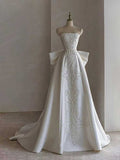 White Strapless Satin Ball Gown with Embroidered Panel & Oversized Bow Back