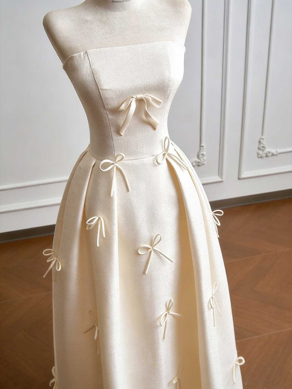 Cream Strapless Ball Gown with Delicate Bow Embellishments & Fitted Bodice