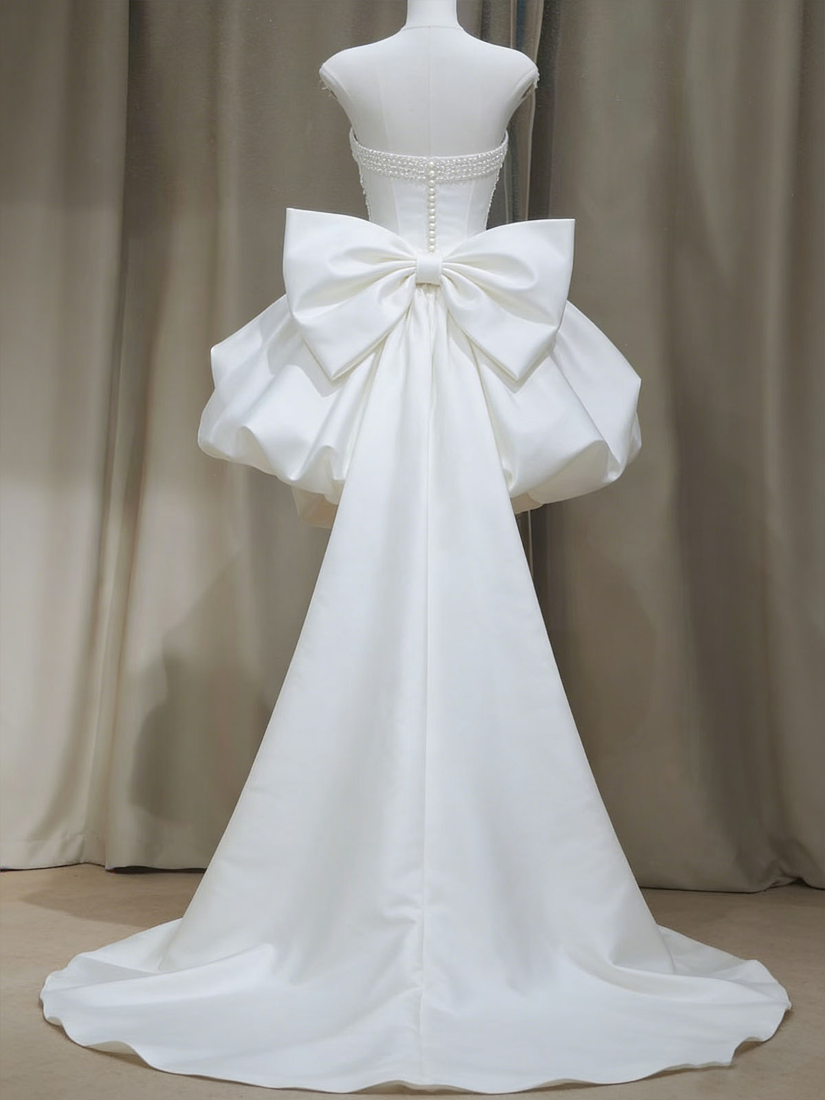 White Strapless High-Low Gown with Pearl Chains & Oversized Bow Back