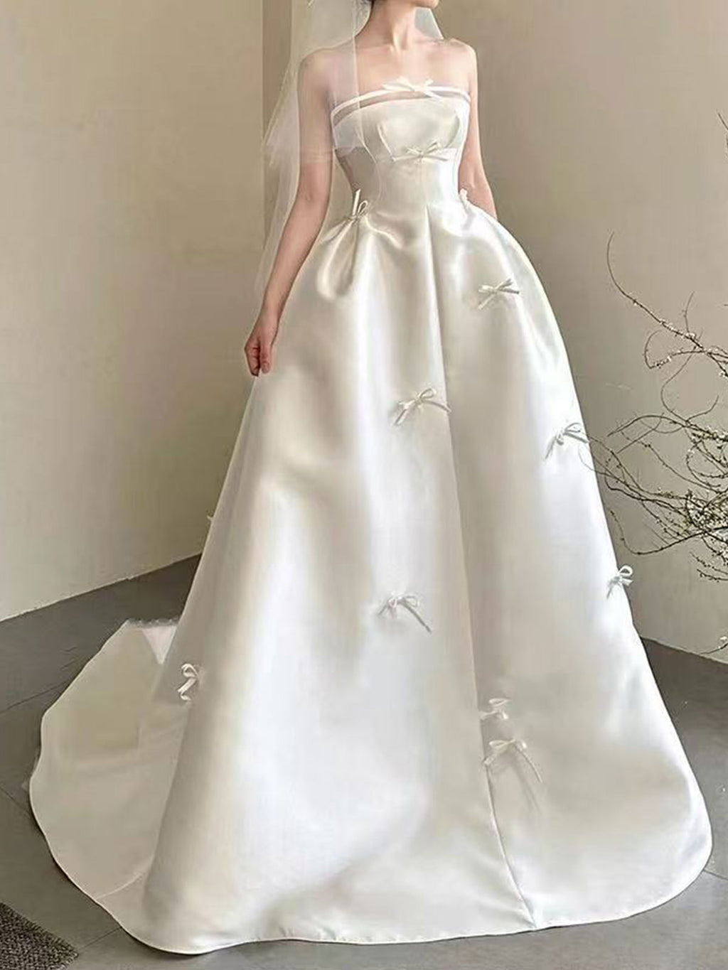 Sweet Strapless Satin Ball Gown with Delicate Bow Embellishments & Sheer Neckline