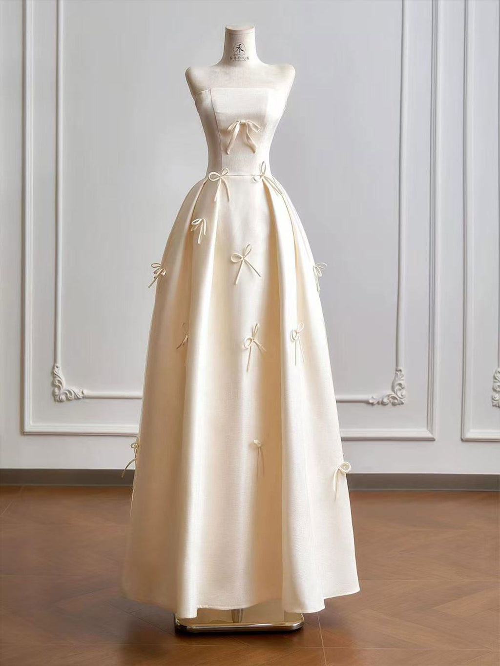 Cream Strapless Ball Gown with Delicate Bow Embellishments & Fitted Bodice