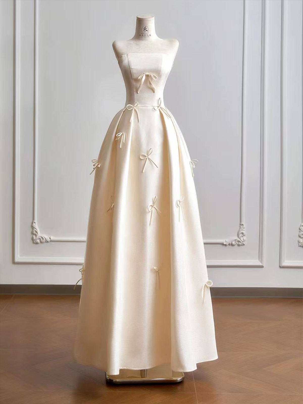 Cream Strapless Ball Gown with Delicate Bow Embellishments & Fitted Bodice